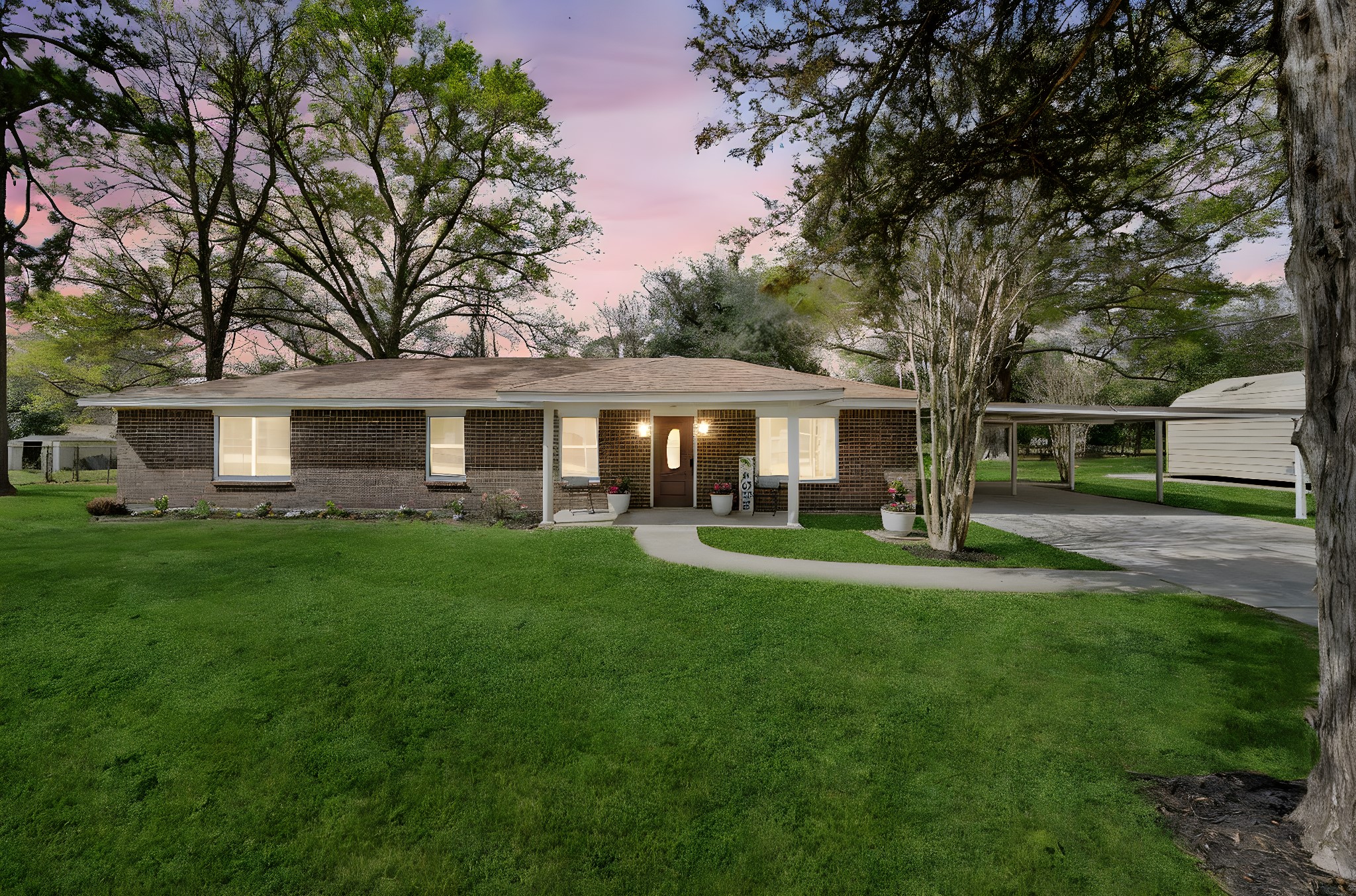 16746 Main Street Splendora, TX 77372 - Photo 7 of 24 a front view of a house with a yard and trees