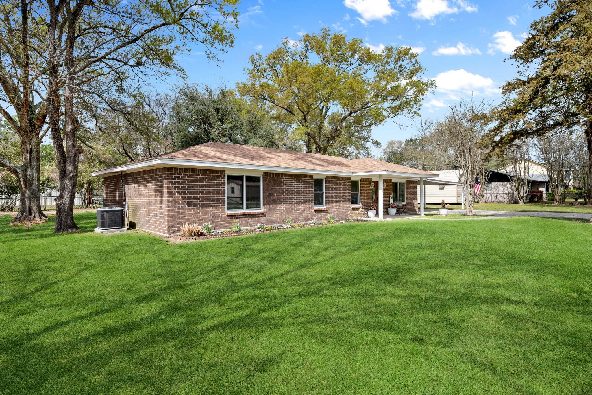 16746 Main Street Splendora, TX 77372 - Photo 8 of 24 a front view of a house with a garden