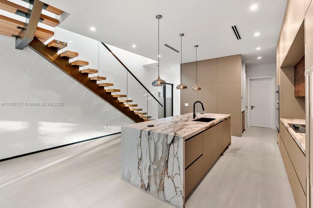 1215 Northeast 11th Avenue, Unit B Fort Lauderdale, FL 33304 - Photo 13 of 62 a large kitchen with stainless steel appliances kitchen island a large island in it