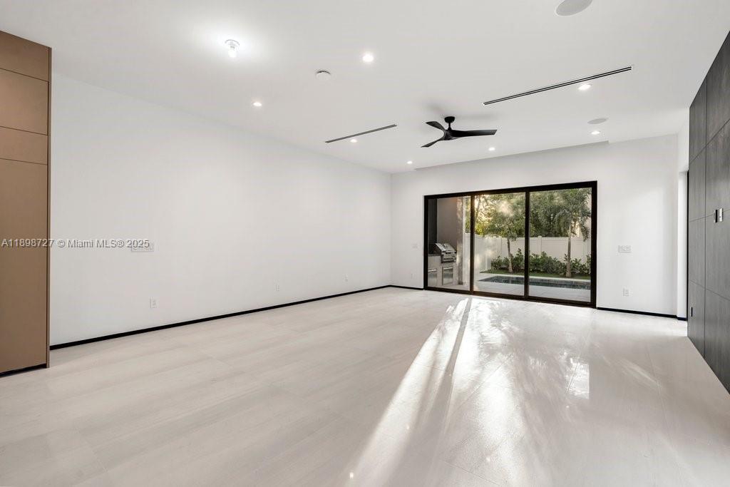 1215 Northeast 11th Avenue, Unit B Fort Lauderdale, FL 33304 - Photo 16 of 62 an empty room with windows and ceiling fan