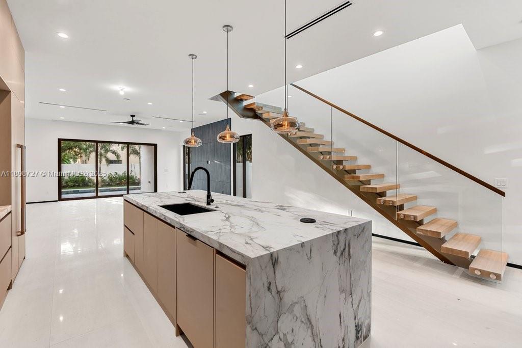 1215 Northeast 11th Avenue, Unit B Fort Lauderdale, FL 33304 - Photo 18 of 62 a kitchen with a sink a stove a refrigerator and white cabinets next to a window