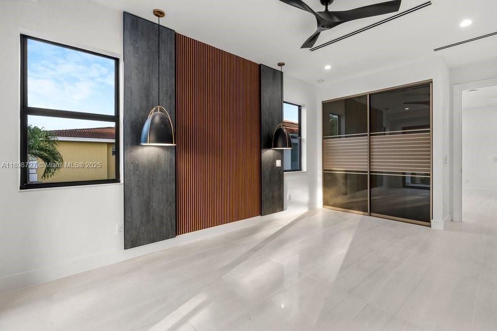 1215 Northeast 11th Avenue, Unit B Fort Lauderdale, FL 33304 - Photo 26 of 62 a view of a hallway with stainless steel appliances wooden floor and living room view