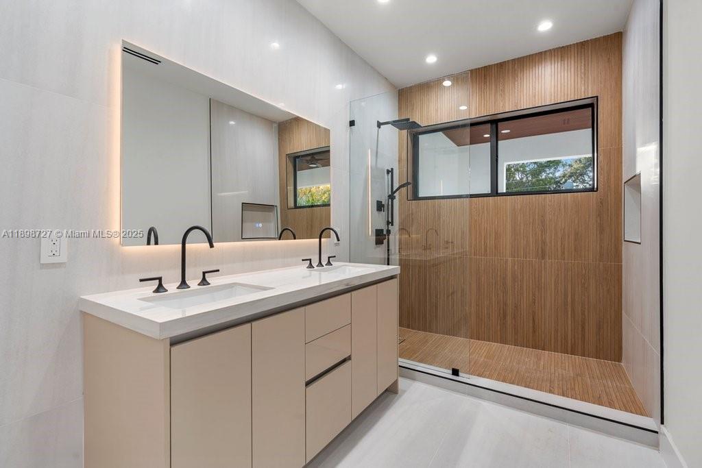 1215 Northeast 11th Avenue, Unit B Fort Lauderdale, FL 33304 - Photo 27 of 62 a bathroom with a double vanity sink mirror and shower