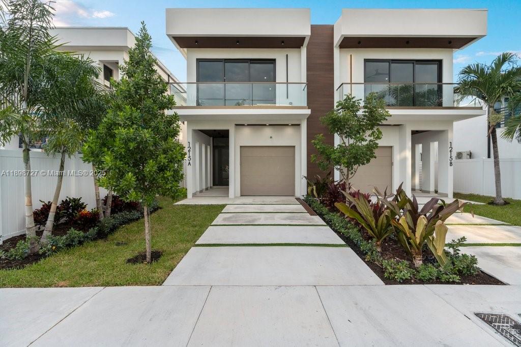 1215 Northeast 11th Avenue, Unit B Fort Lauderdale, FL 33304 - Photo 3 of 62 a front view of house and yard with trees