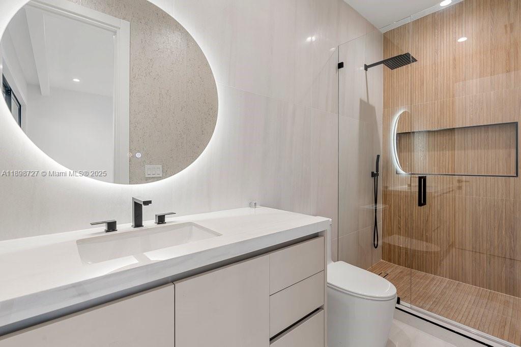 1215 Northeast 11th Avenue, Unit B Fort Lauderdale, FL 33304 - Photo 33 of 62 a bathroom with a sink a toilet and shower