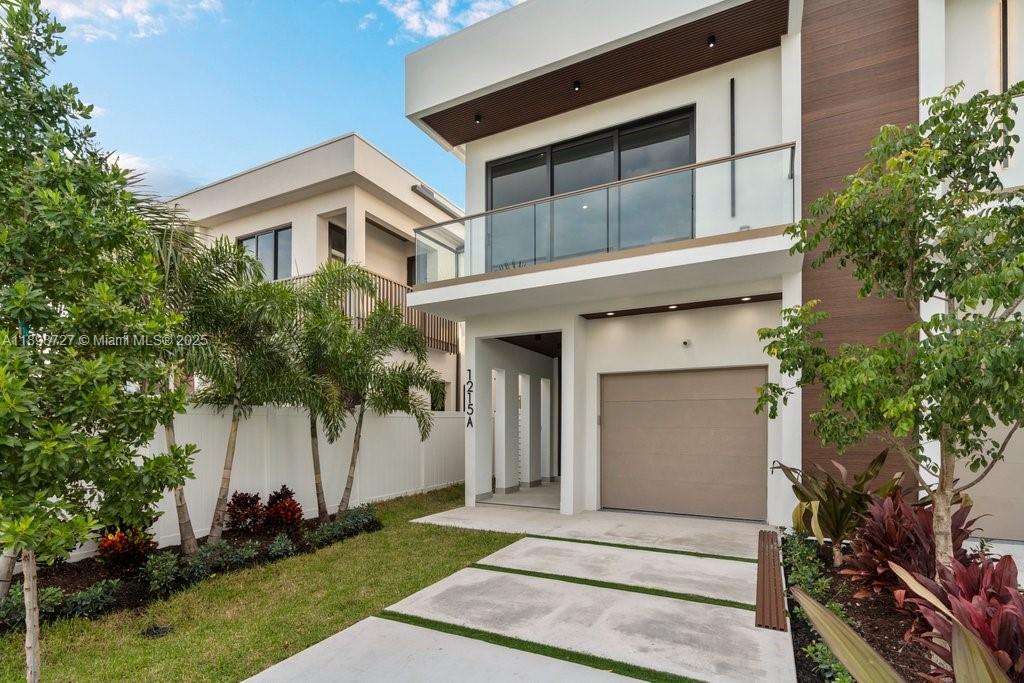 1215 Northeast 11th Avenue, Unit B Fort Lauderdale, FL 33304 - Photo 4 of 62 a front view of a house with a garden