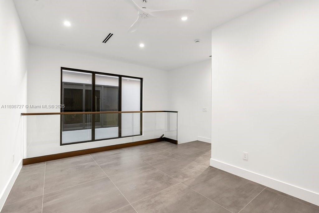 1215 Northeast 11th Avenue, Unit B Fort Lauderdale, FL 33304 - Photo 46 of 62 an empty room with sliding glass door