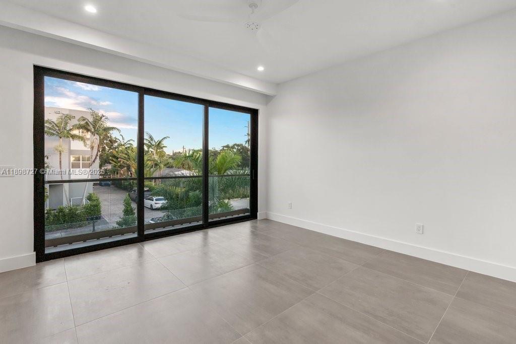 1215 Northeast 11th Avenue, Unit B Fort Lauderdale, FL 33304 - Photo 55 of 62 wooden floor in an empty room with a large window