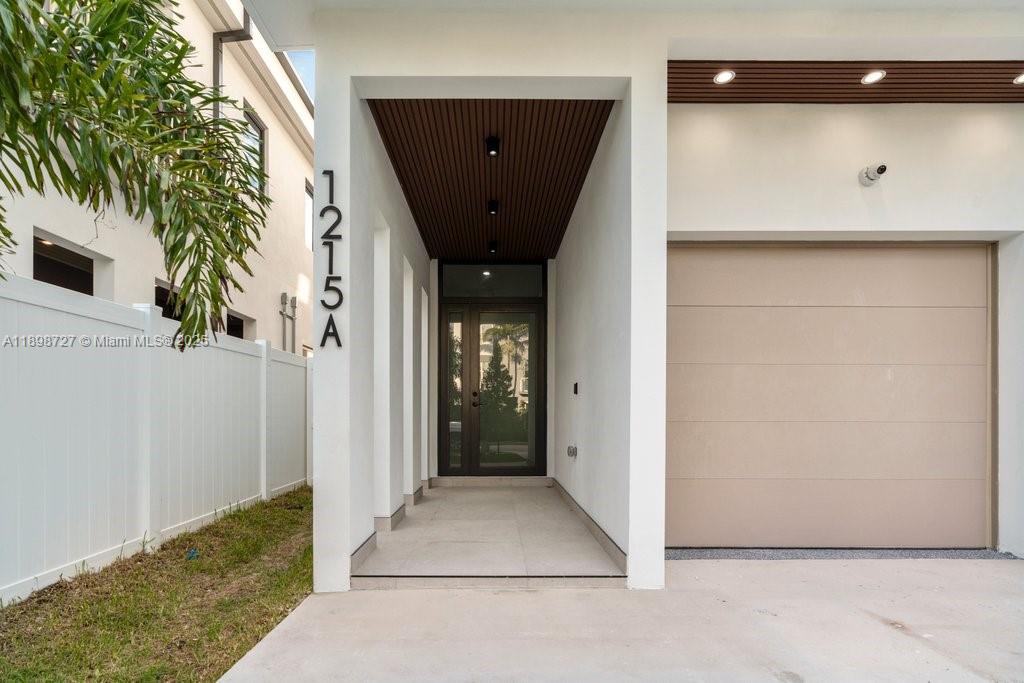 1215 Northeast 11th Avenue, Unit B Fort Lauderdale, FL 33304 - Photo 6 of 62 a view of a hallway with wooden door