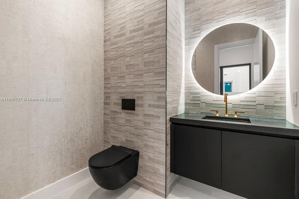 1215 Northeast 11th Avenue, Unit B Fort Lauderdale, FL 33304 - Photo 10 of 62 a bathroom with a sink and a mirror