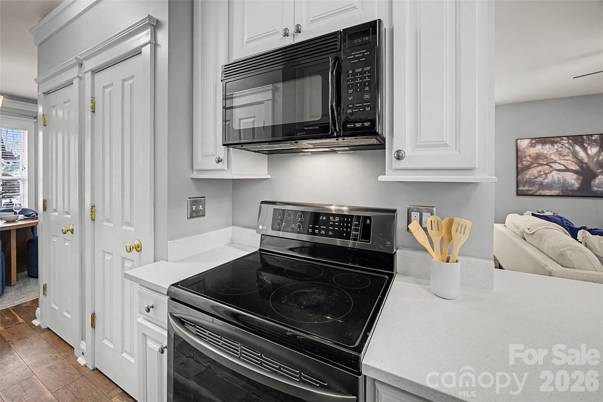 8123 Bud Henderson Road Huntersville, NC 28078 - Photo 12 of 48 a kitchen with stainless steel appliances granite countertop a stove a microwave and cabinets