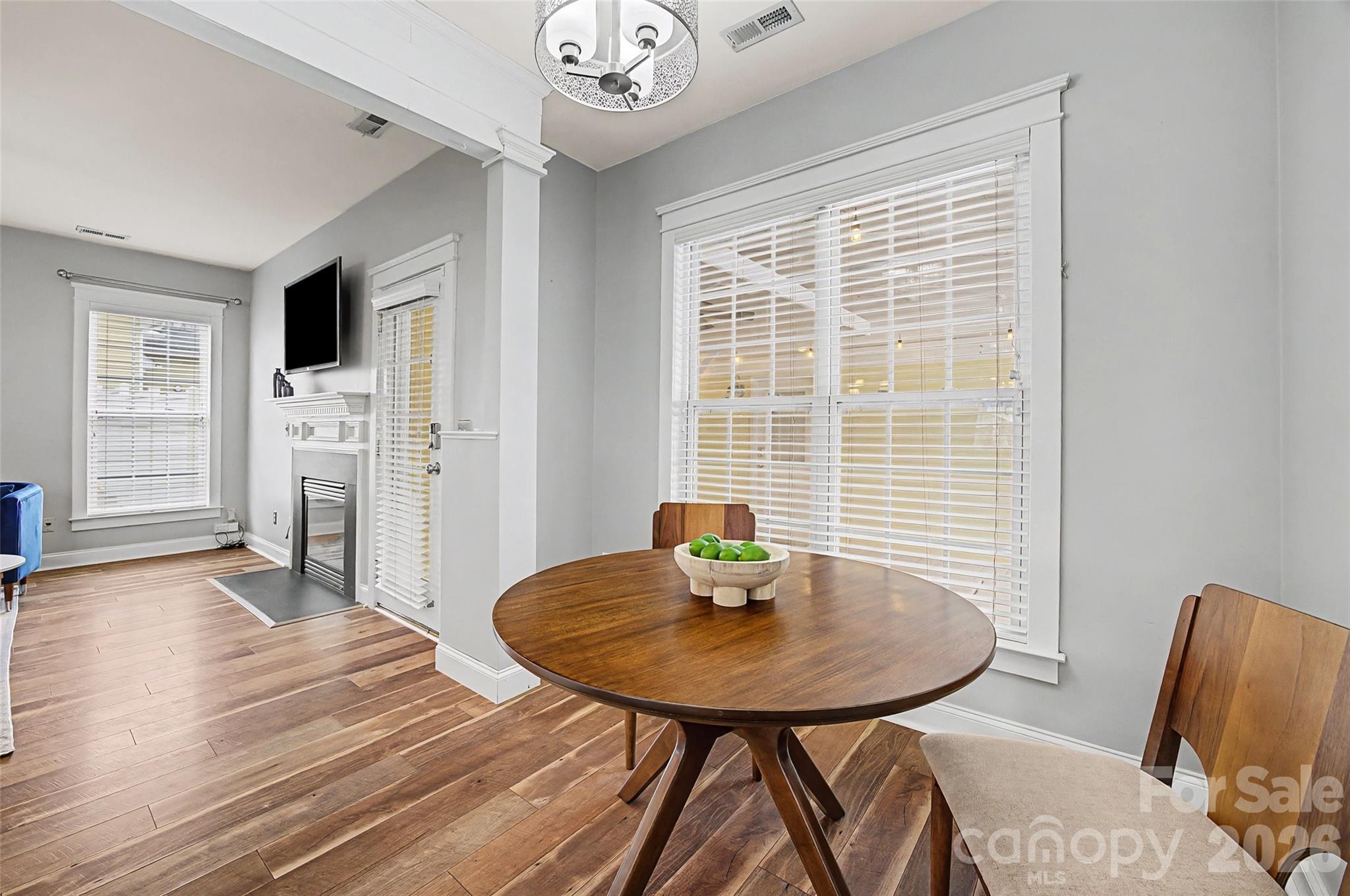 8123 Bud Henderson Road Huntersville, NC 28078 - Photo 15 of 48 a view of a dining room with furniture and wooden floor