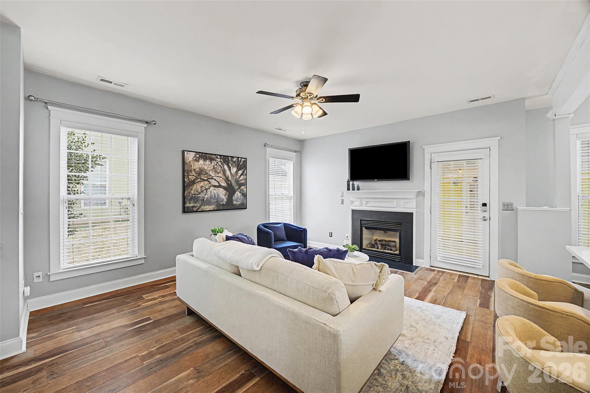 8123 Bud Henderson Road Huntersville, NC 28078 - Photo 20 of 48 a living room with furniture a fireplace and a flat screen tv