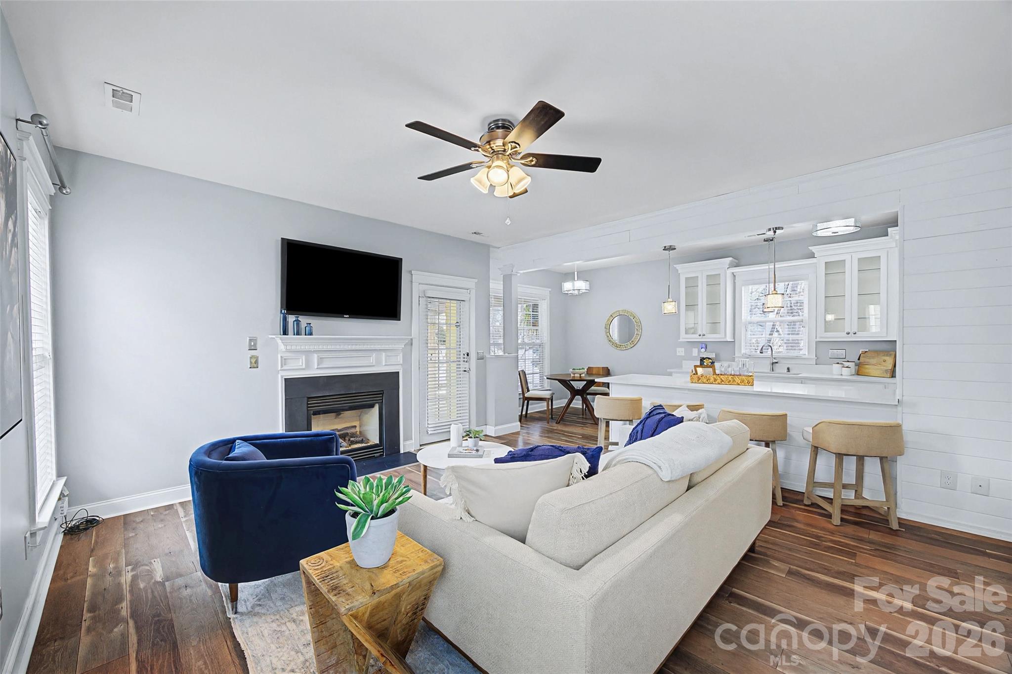 8123 Bud Henderson Road Huntersville, NC 28078 - Photo 21 of 48 a living room with furniture a fireplace and a flat screen tv