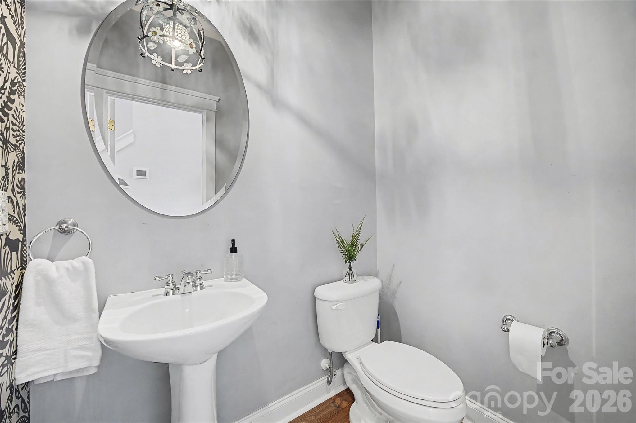 8123 Bud Henderson Road Huntersville, NC 28078 - Photo 22 of 48 a white toilet sitting next to a bathroom sink