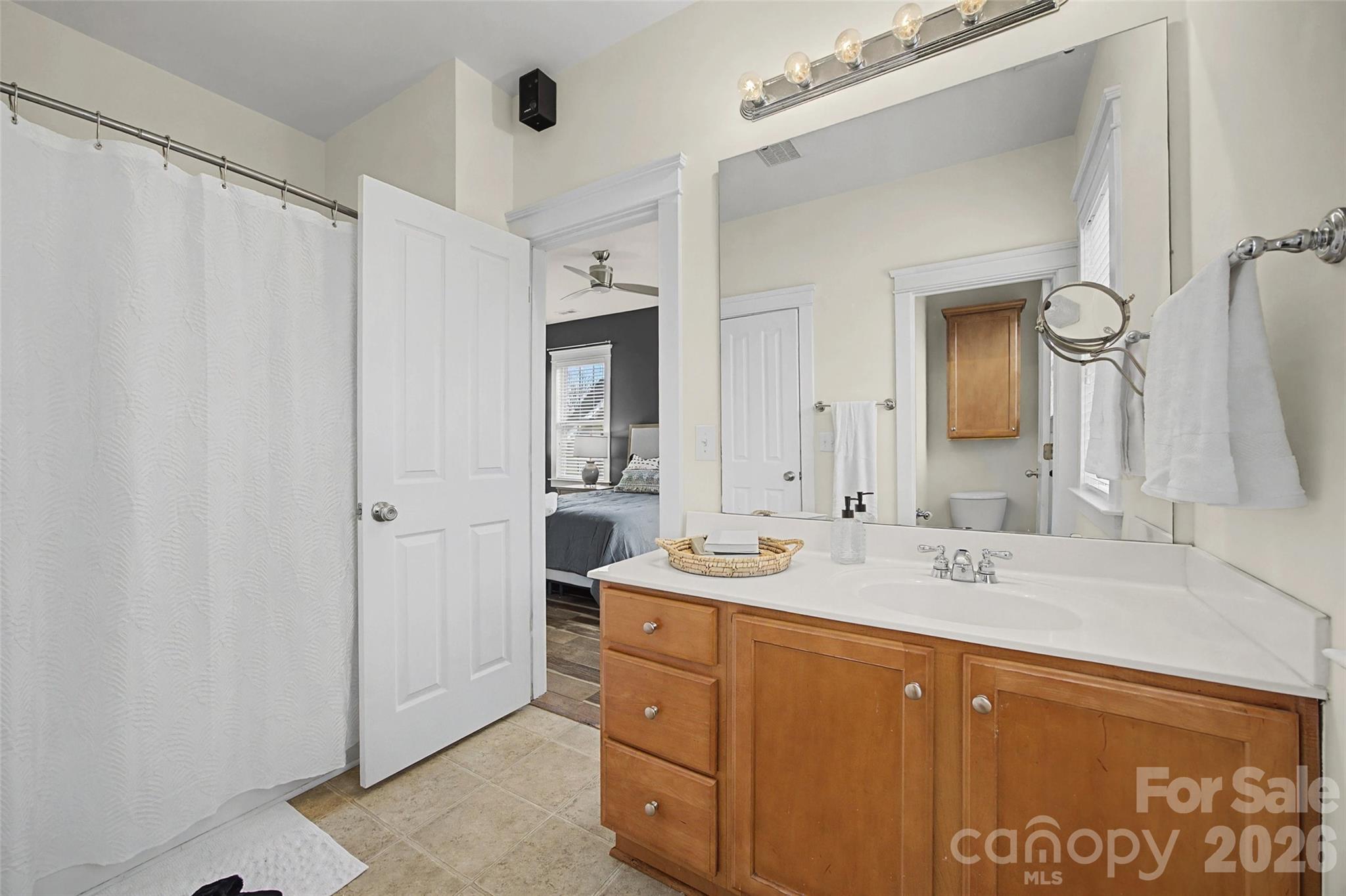 8123 Bud Henderson Road Huntersville, NC 28078 - Photo 27 of 48 a bathroom with a double vanity sink mirror and