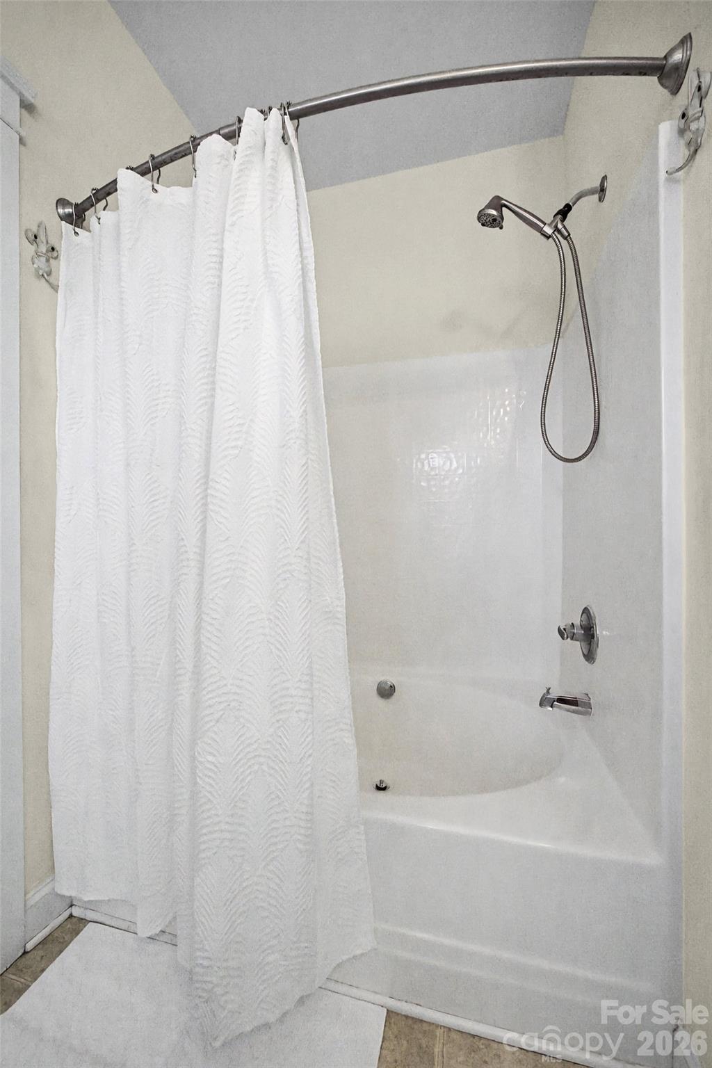 8123 Bud Henderson Road Huntersville, NC 28078 - Photo 28 of 48 a bathroom with a shower curtain and a bathtub