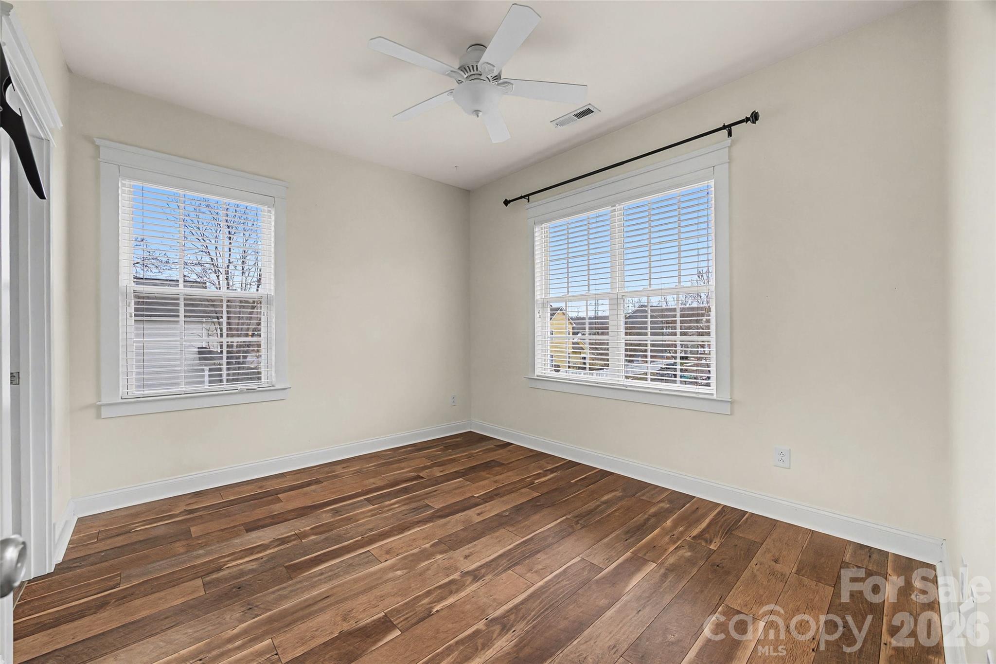 8123 Bud Henderson Road Huntersville, NC 28078 - Photo 30 of 48 a view of an empty room with wooden floor and a window