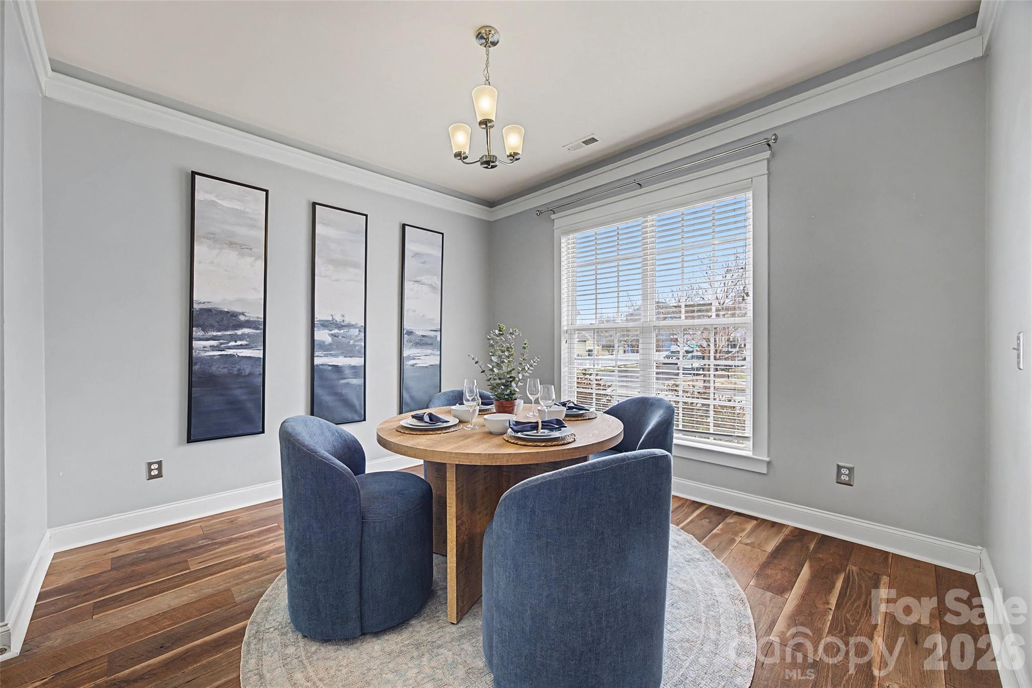 8123 Bud Henderson Road Huntersville, NC 28078 - Photo 5 of 48 a dining room with furniture a chandelier and wooden floor