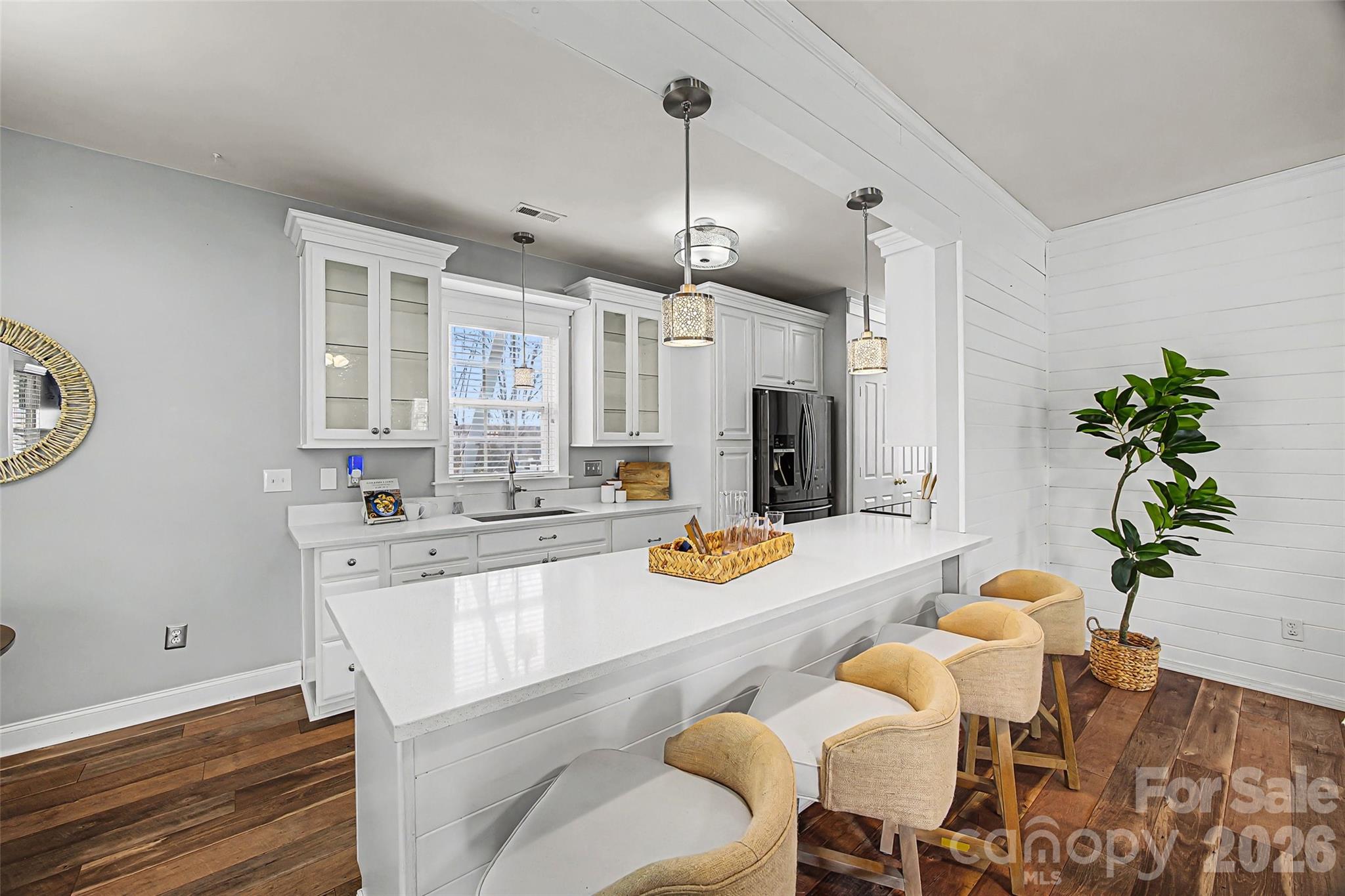 8123 Bud Henderson Road Huntersville, NC 28078 - Photo 8 of 48 a kitchen with stainless steel appliances a white table chairs and a refrigerator