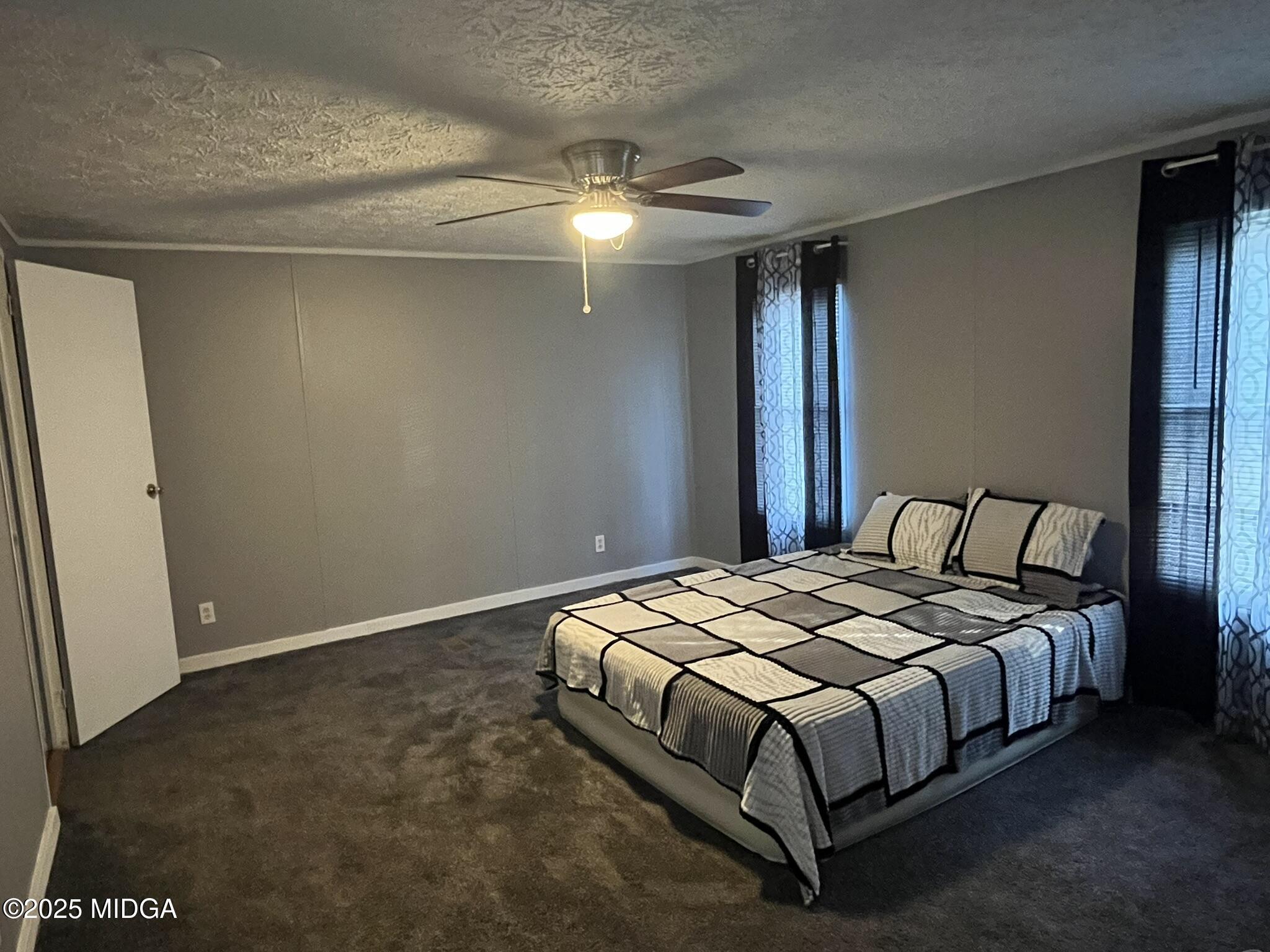 111 Mandy Court Macon, GA 31217 - Photo 2 of 12 a large bed sitting in a bedroom next to a window