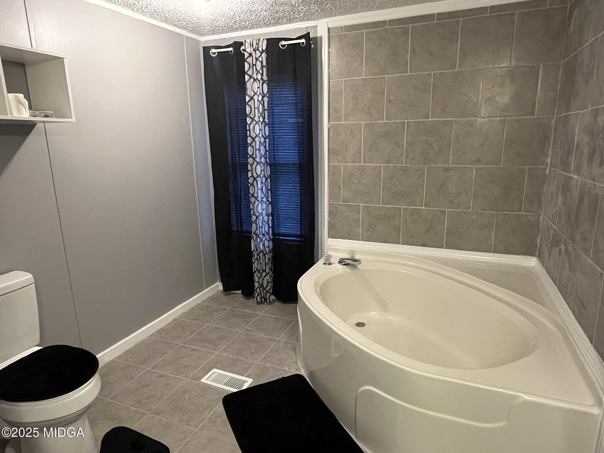 111 Mandy Court Macon, GA 31217 - Photo 4 of 12 a bathroom with a bathtub and a shower