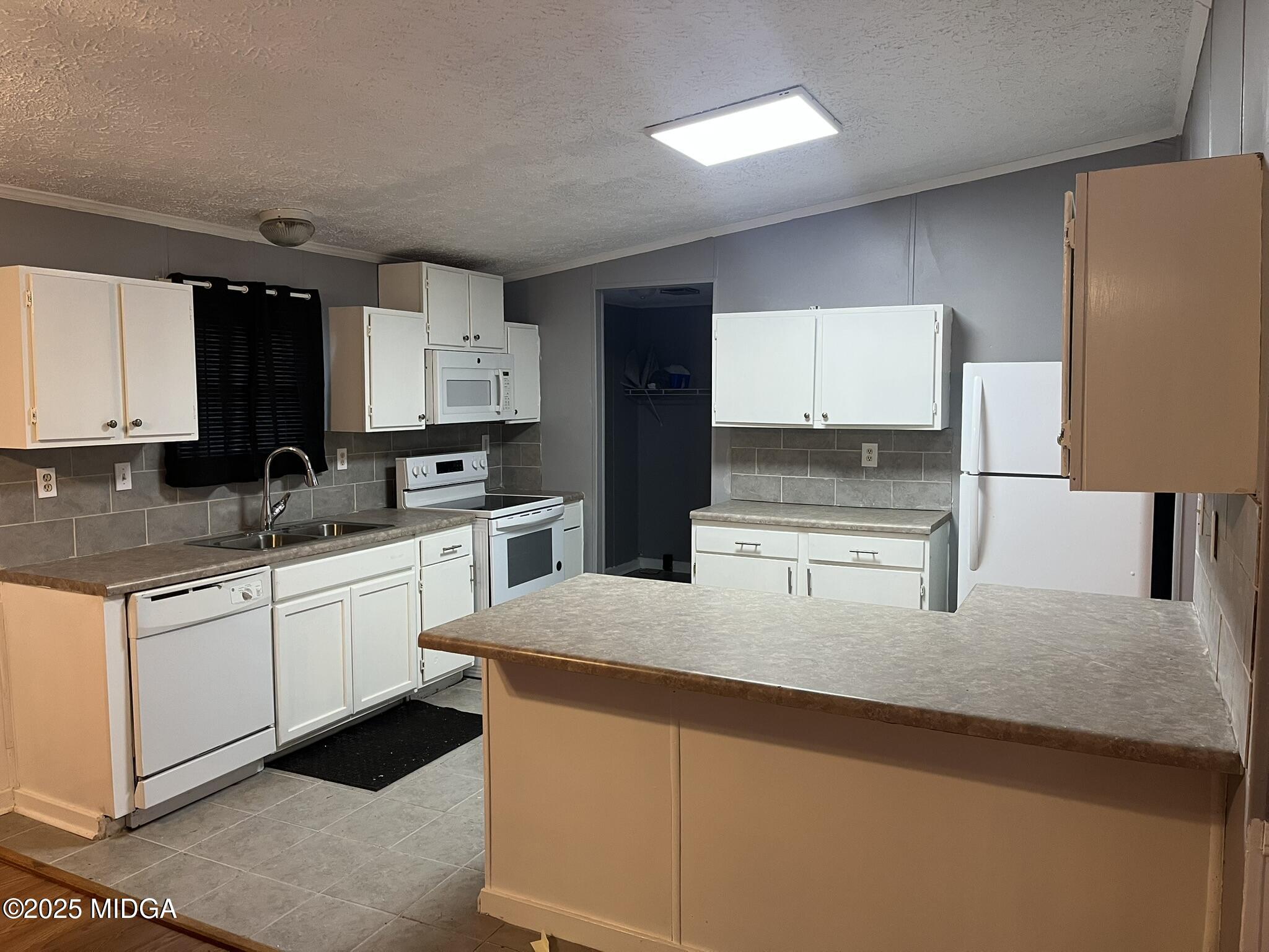 111 Mandy Court Macon, GA 31217 - Photo 8 of 12 a kitchen with stainless steel appliances granite countertop a sink stove and microwave