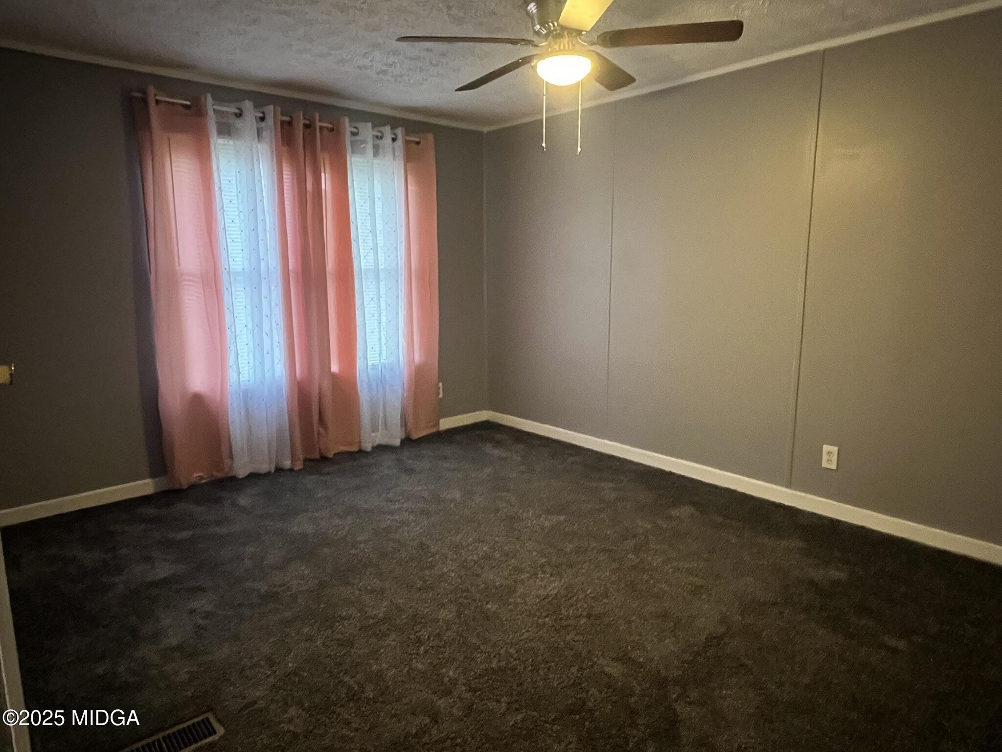 111 Mandy Court Macon, GA 31217 - Photo 9 of 12 an empty room with windows and fan