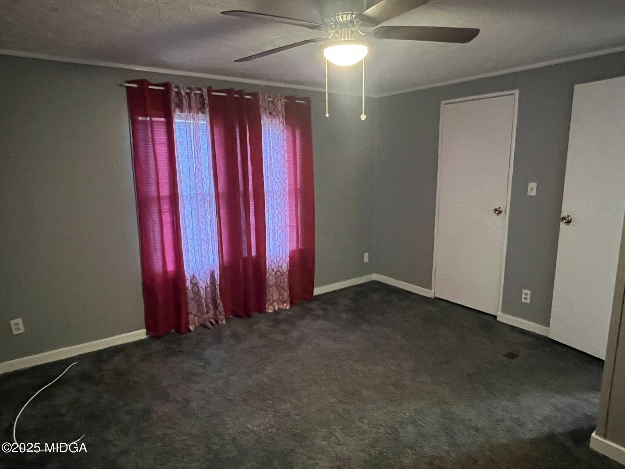 111 Mandy Court Macon, GA 31217 - Photo 10 of 12 a view of a room with red walls and a ceiling fan