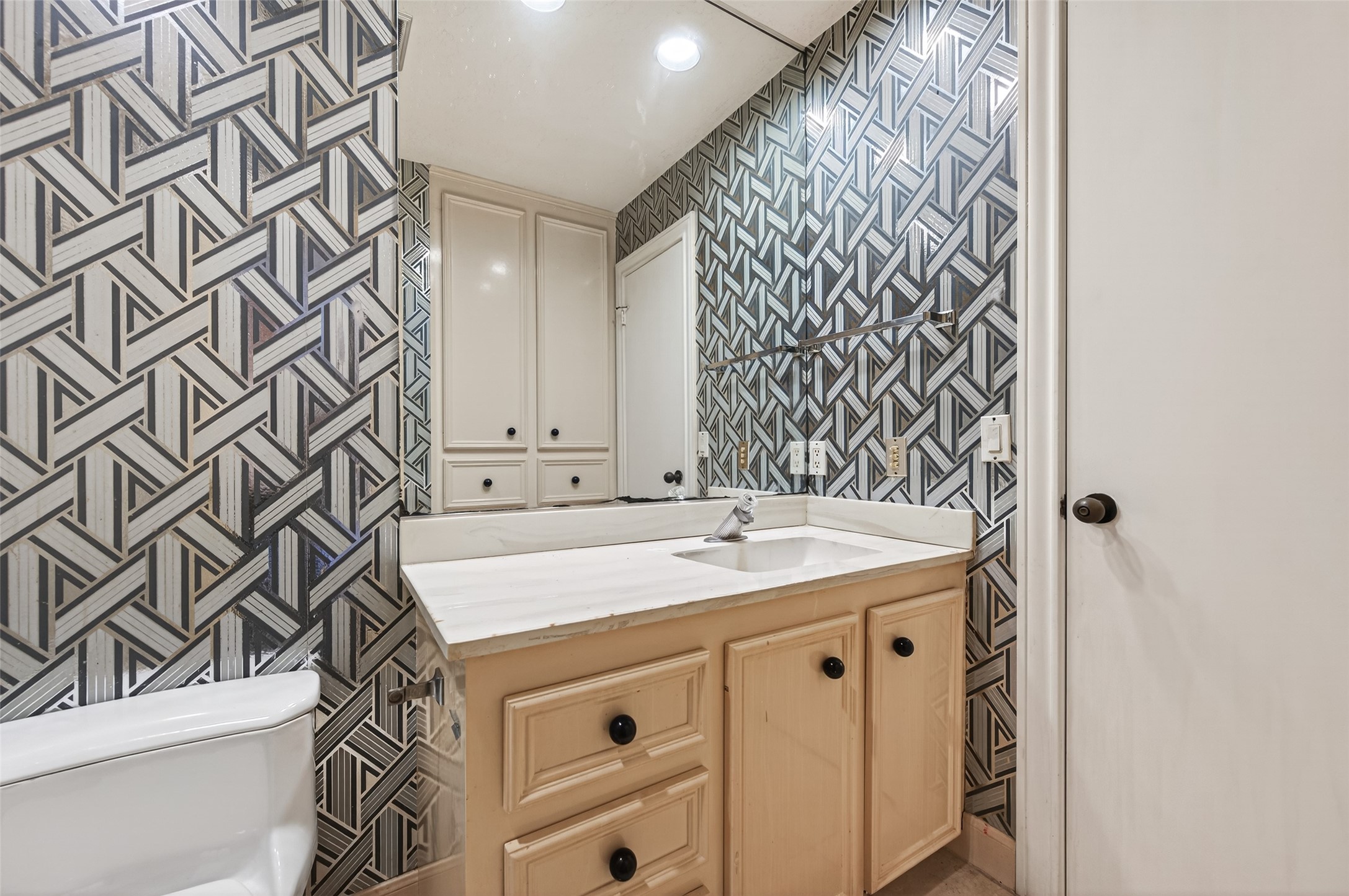 8103 Lake Edge Court Houston, TX 77071 - Photo 32 of 48 Well-appointed full bath featuring bold patterned walls and functional single-sink vanity