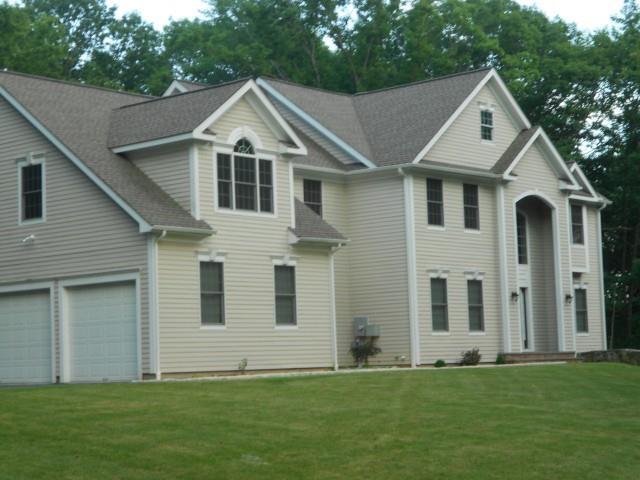 19 Meridian Ridge Drive Newtown, CT 06470 - Photo 1 of 1 a front view of a house with a garden