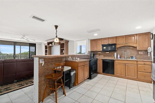 a kitchen with stainless steel appliances granite countertop a stove top oven microwave and a refrigerator