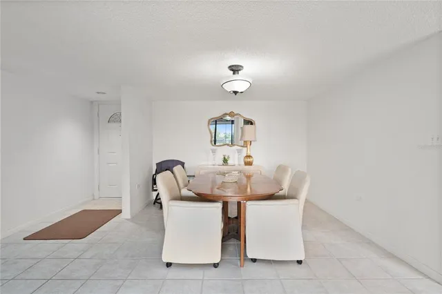 a dining room with furniture and a window