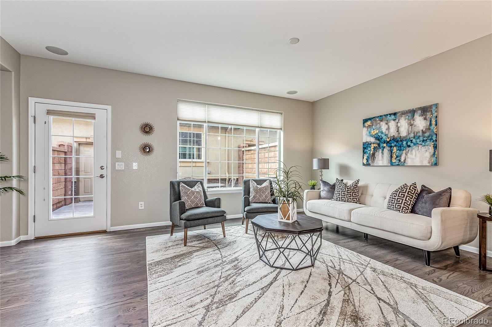 592 Brookhurst Avenue, Unit 26B Highlands Ranch, CO 80129 - Photo 4 of 19 a living room with furniture and wooden floor