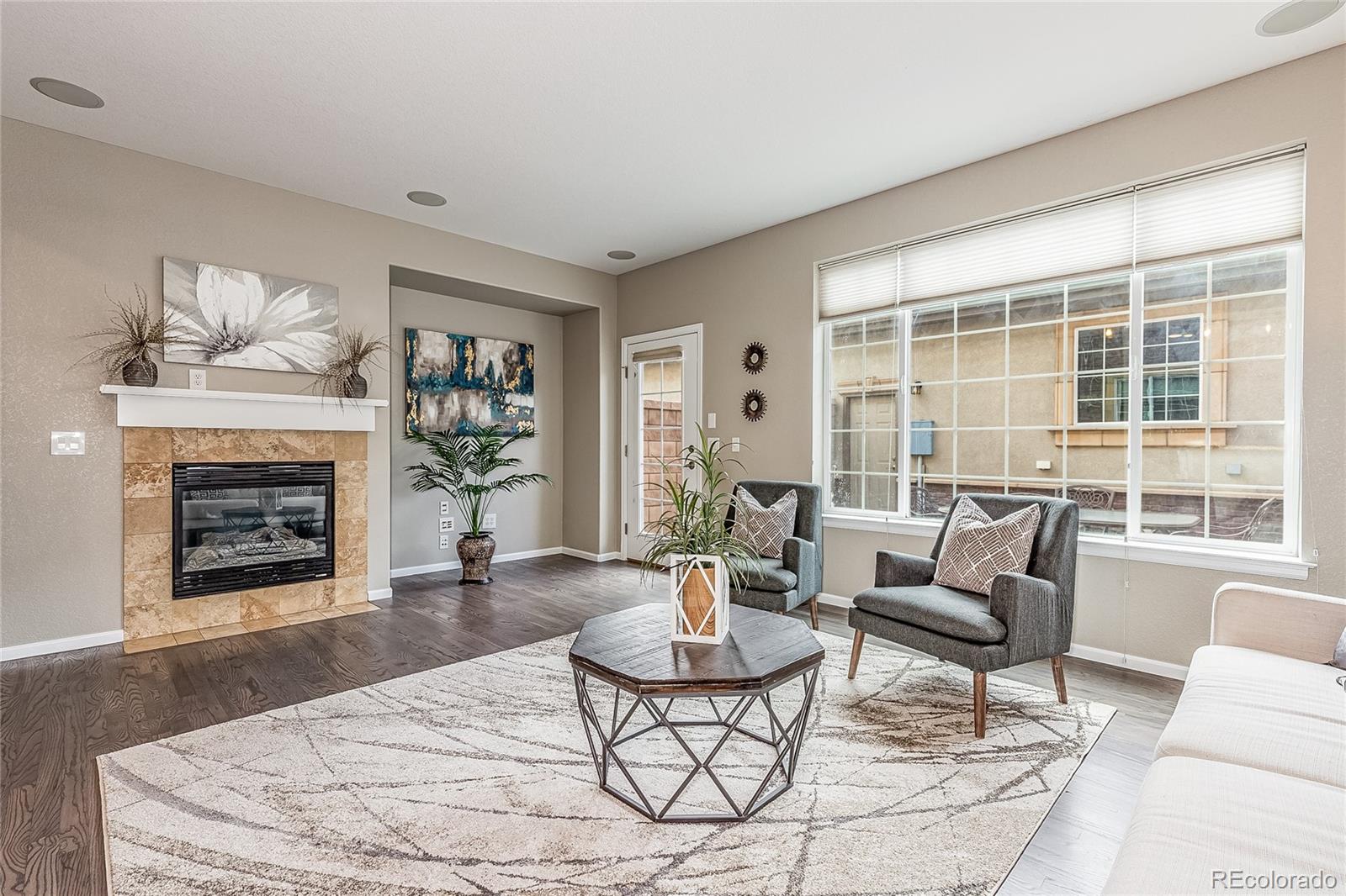 592 Brookhurst Avenue, Unit 26B Highlands Ranch, CO 80129 - Photo 5 of 19 a living room with furniture and a fireplace