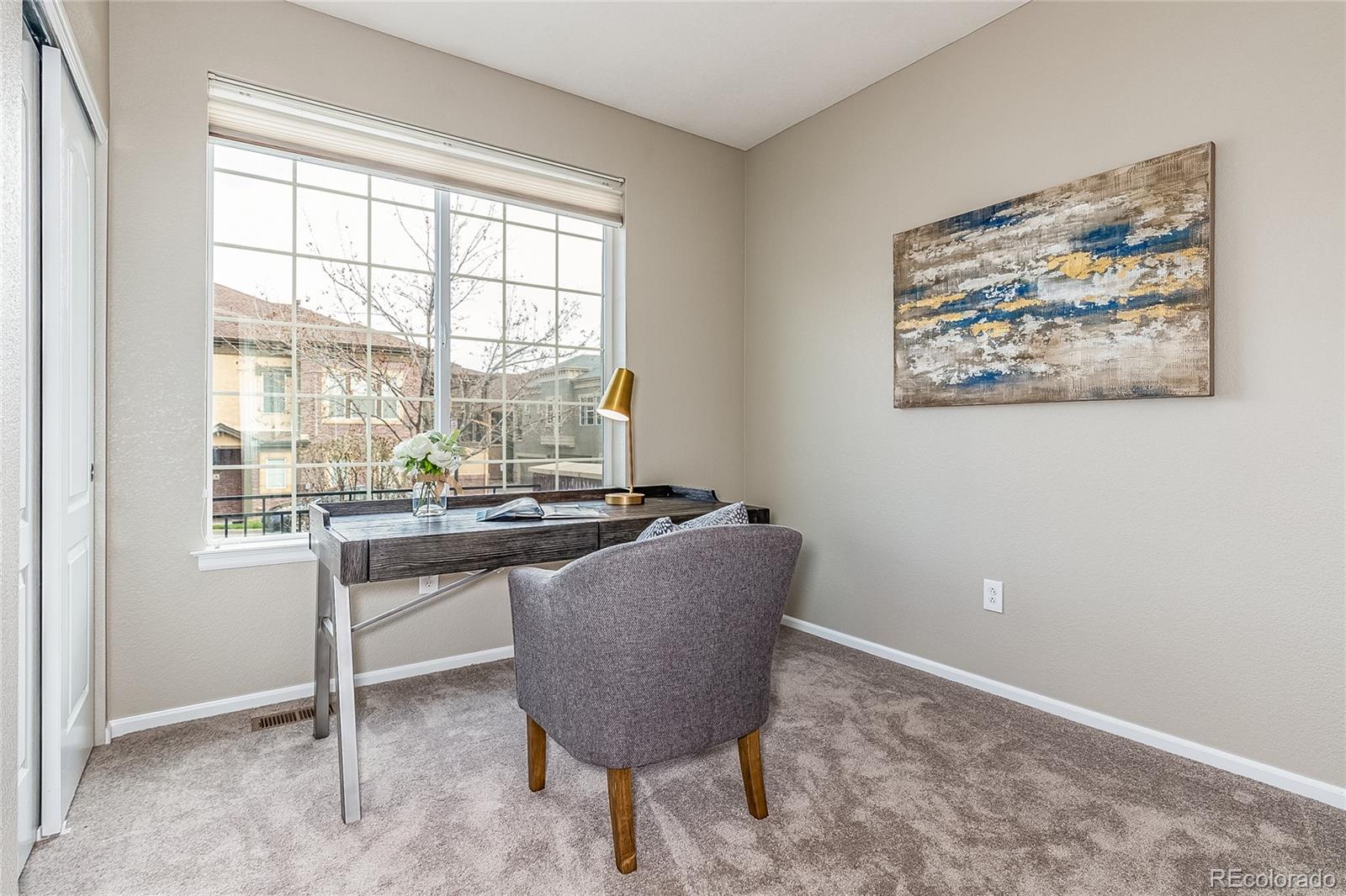 592 Brookhurst Avenue, Unit 26B Highlands Ranch, CO 80129 - Photo 10 of 19 a living room with furniture and a window