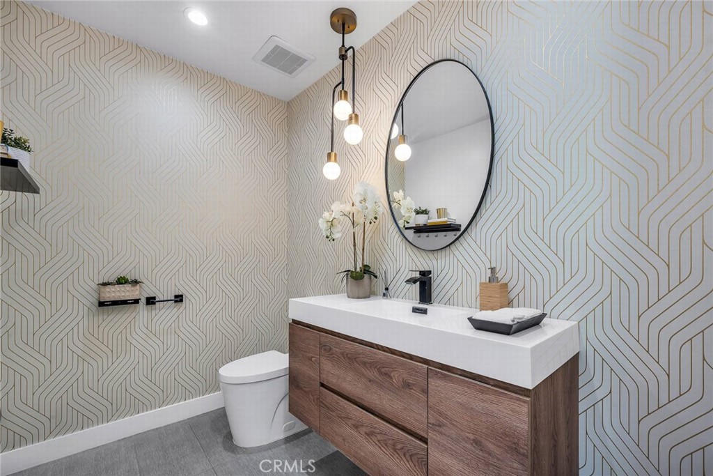 5110 Greenbush Avenue Sherman Oaks, CA 91423 - Photo 16 of 40 a bathroom with a toilet sink mirror and vanity