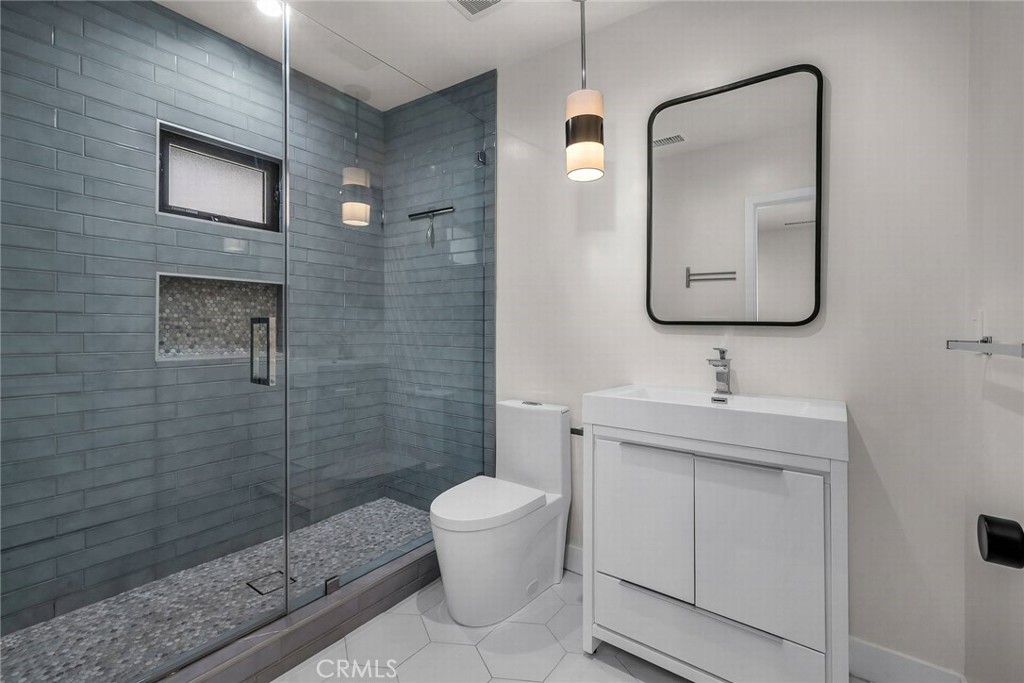 5110 Greenbush Avenue Sherman Oaks, CA 91423 - Photo 21 of 40 a bathroom with a toilet sink and mirror