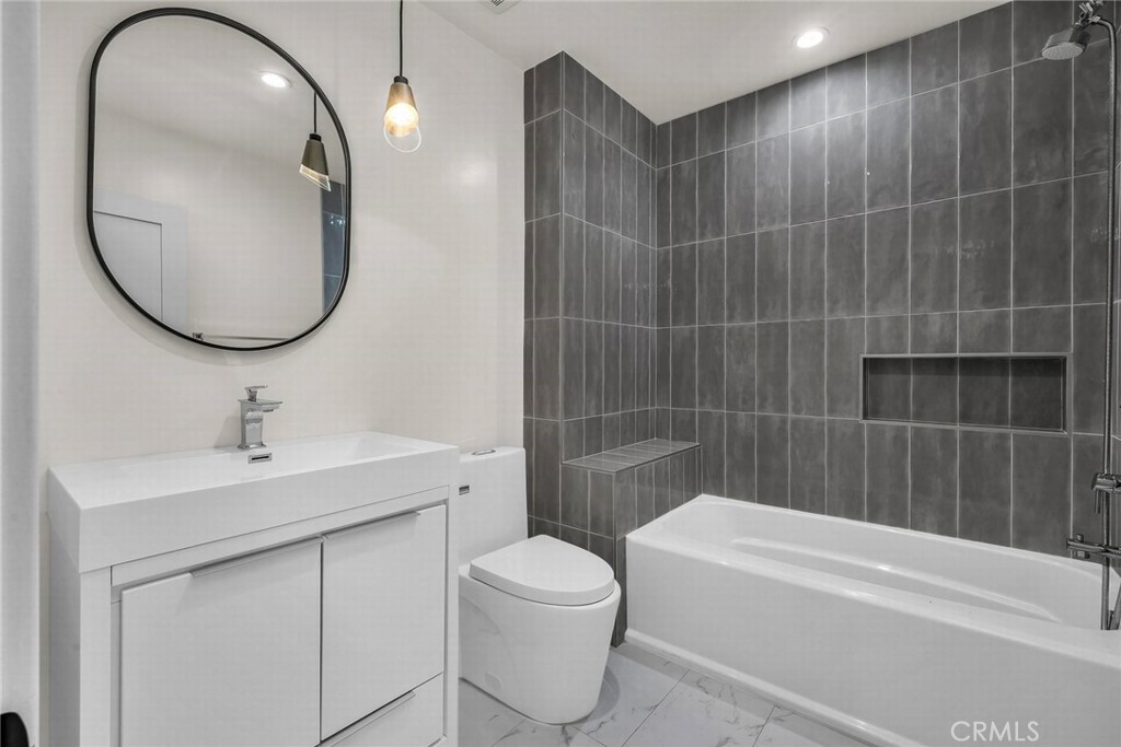 5110 Greenbush Avenue Sherman Oaks, CA 91423 - Photo 26 of 40 a bathroom with a sink a toilet and a mirror