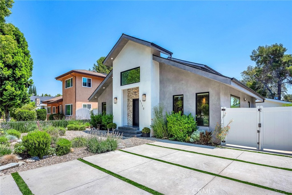 5110 Greenbush Avenue Sherman Oaks, CA 91423 - Photo 3 of 40 a front view of a house with a yard and potted plants