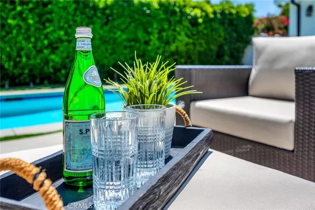 a view of a patio with couches table and chairs and potted plants