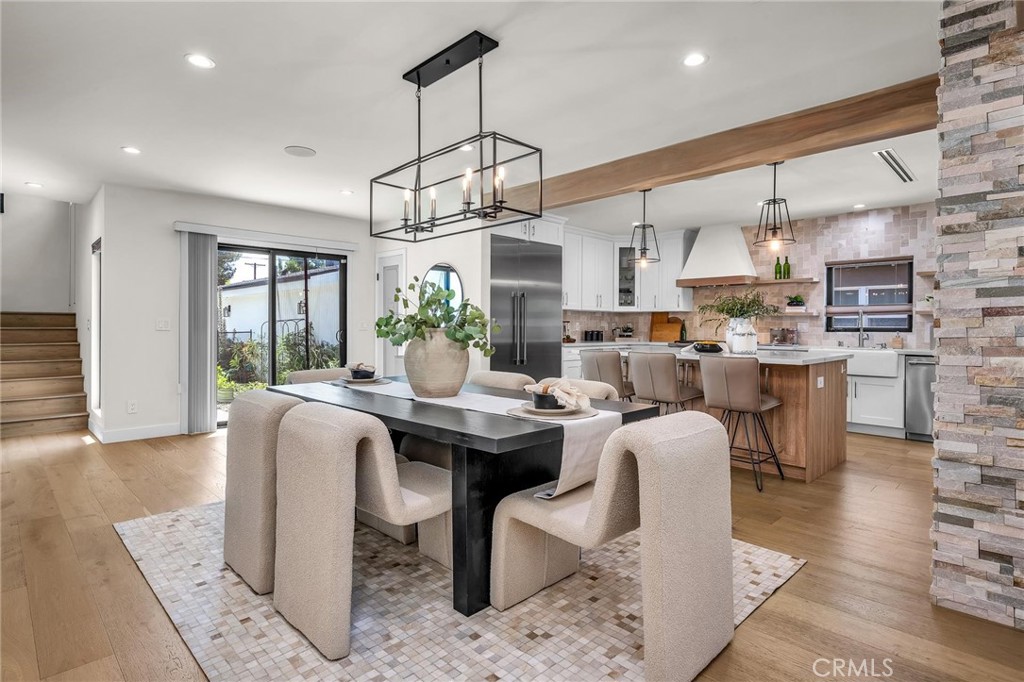 5110 Greenbush Avenue Sherman Oaks, CA 91423 - Photo 10 of 40 a dining room with kitchen island stainless steel appliances furniture a chandelier and a view of kitchen