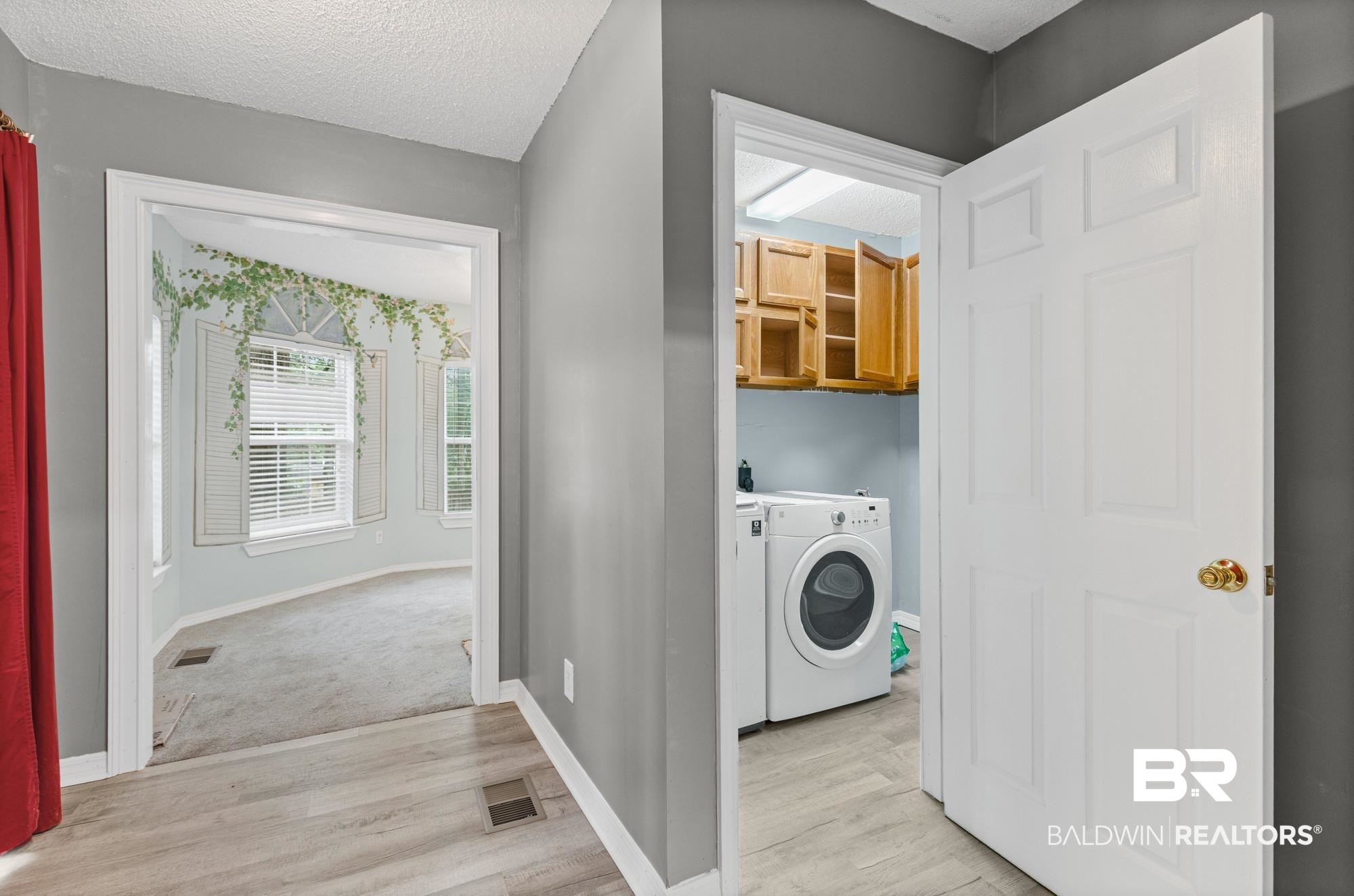8675 Hunters Pointe Drive North Theodore, AL 36582 - Photo 17 of 20 Dedicated laundry area with upper cabinetry and tiled flooring