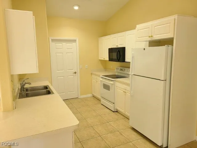 a kitchen with stainless steel appliances a refrigerator sink and stove