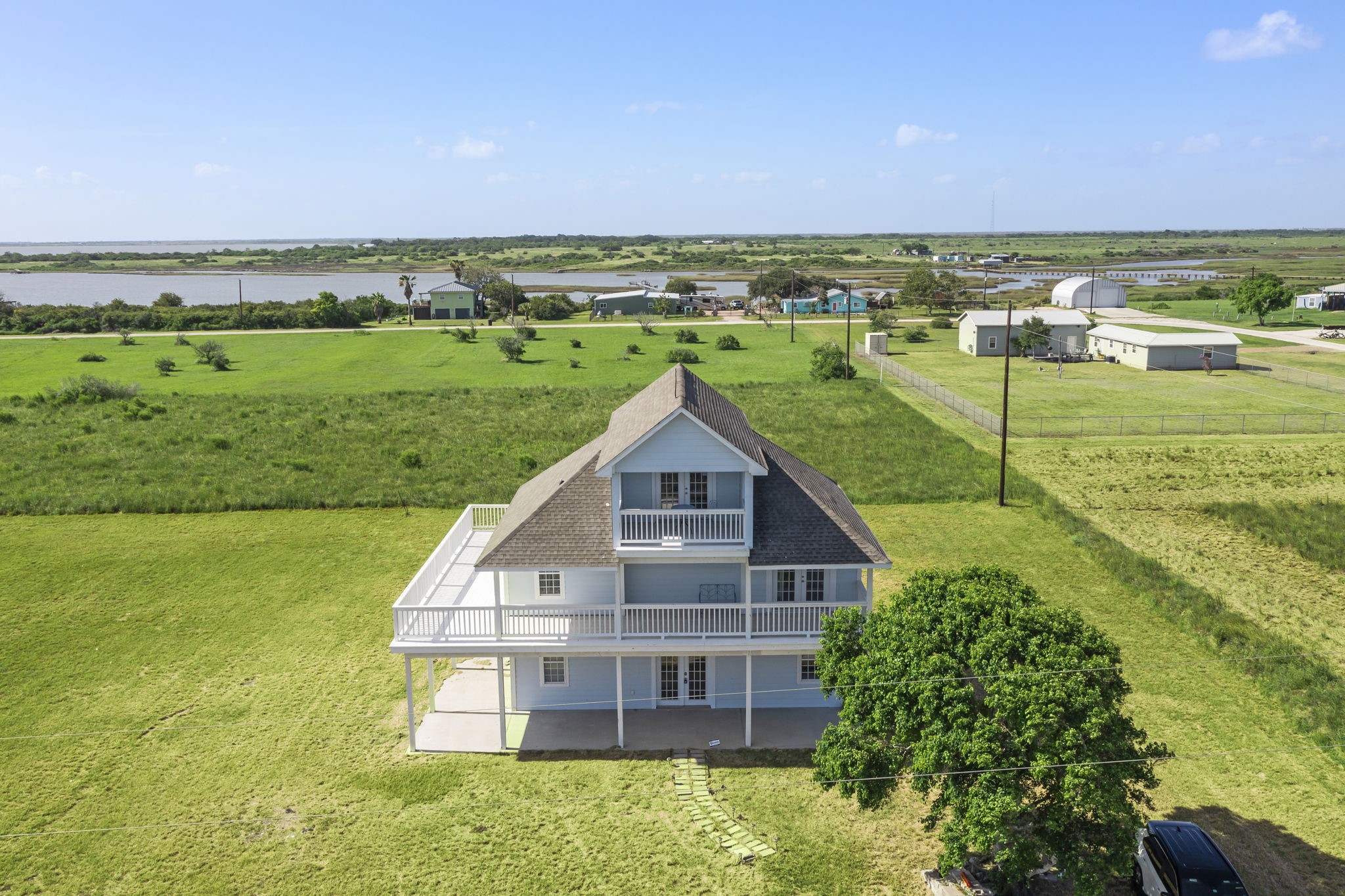 3582 County Road 476 Palacios, TX 77465 - Photo 1 of 31 a view of a big house with a big yard and large trees