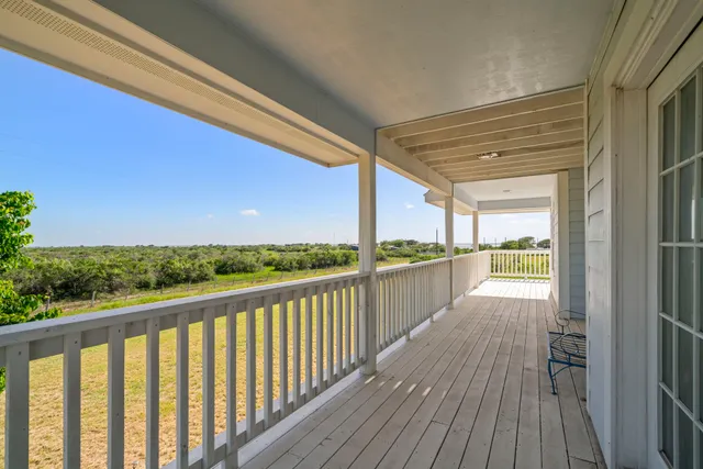 a view of a balcony with wooden floor