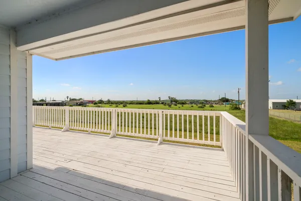 a view of a balcony with wooden floor