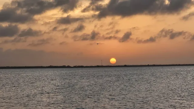 a view of an ocean beach and mountain