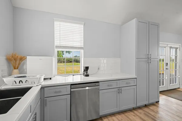 a kitchen with a sink cabinets appliances and a window