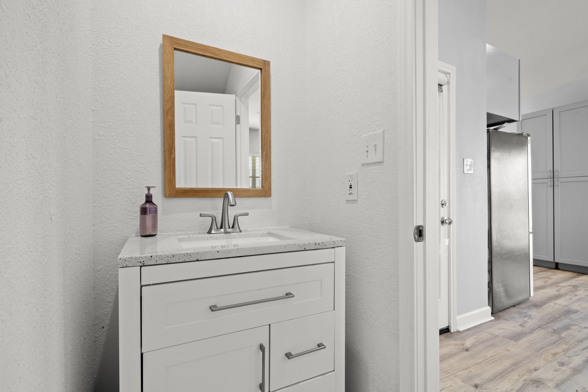 3582 County Road 476 Palacios, TX 77465 - Photo 9 of 31 a bathroom with a sink vanity granite and a mirror